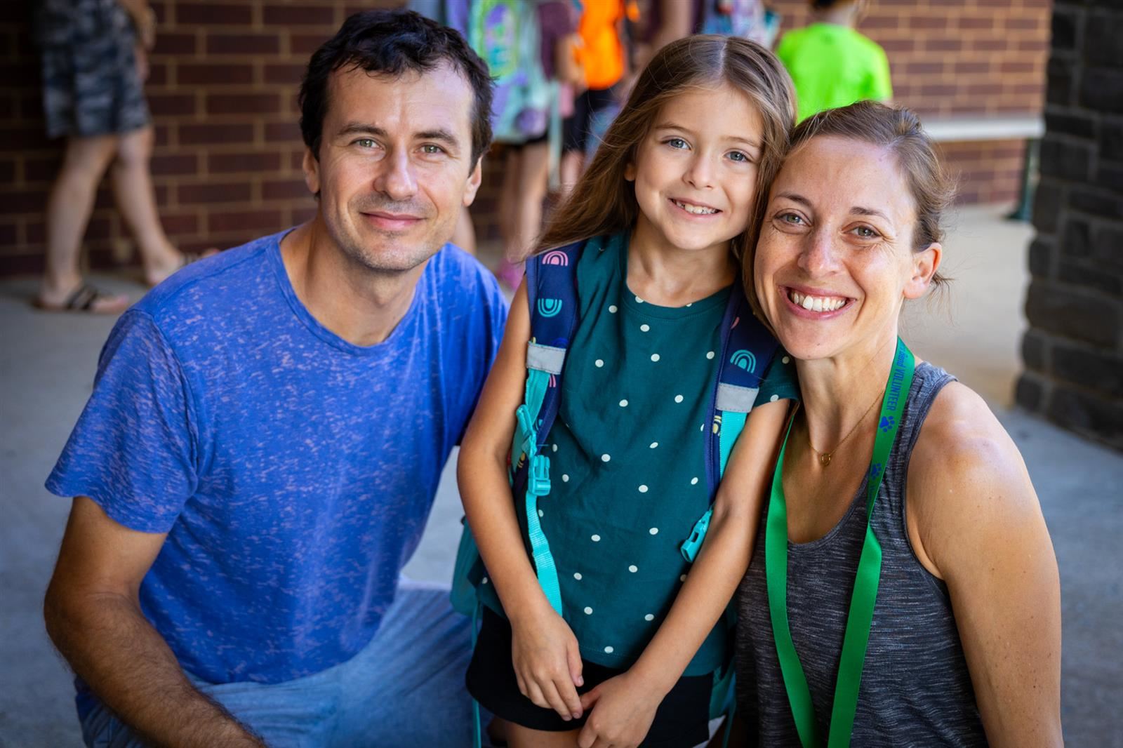 parents and girl smiling